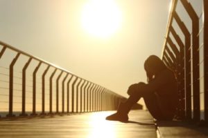 a woman reflects in her depression treatment center