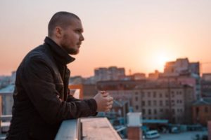 a man contemplates entering a heroin addiction treatment center