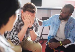 a man receives help in an opiate detox center